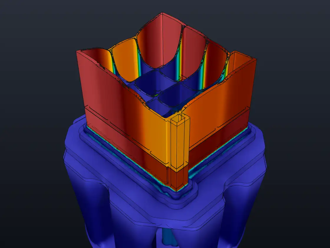 Flow simulation result in ExtrusionFlow 3D Studio: a multi-chamber hollow profile leaving a porthole die, coloured by exit velocity from 0 to 28 mm/s